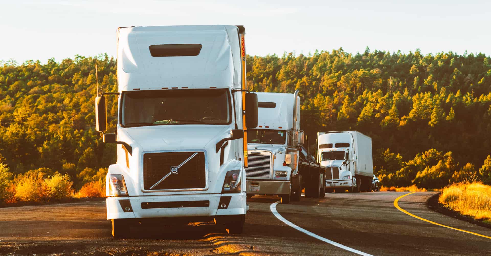 white volvo semi truck on side of road 2199293